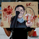 A student holds a placard honouring the woman that was shot in the eye at a protest, during a rally to call for political reforms outside City Hall in Hong Kong, China, August 22, 2019.